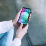 Smartphone holding in womans hand with blank screen on the