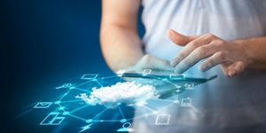 Close up of hand holding tablet with cloud network technology