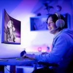 Teenager gaming online in his bedroom